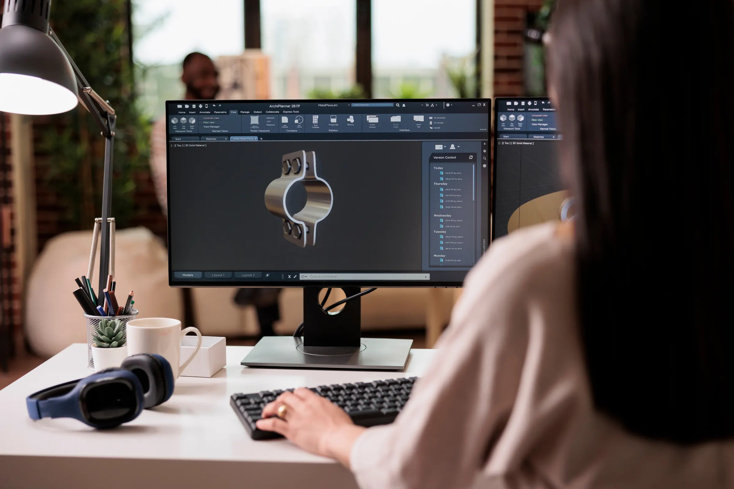 Engineer reviewing a 3D model on a computer monitor