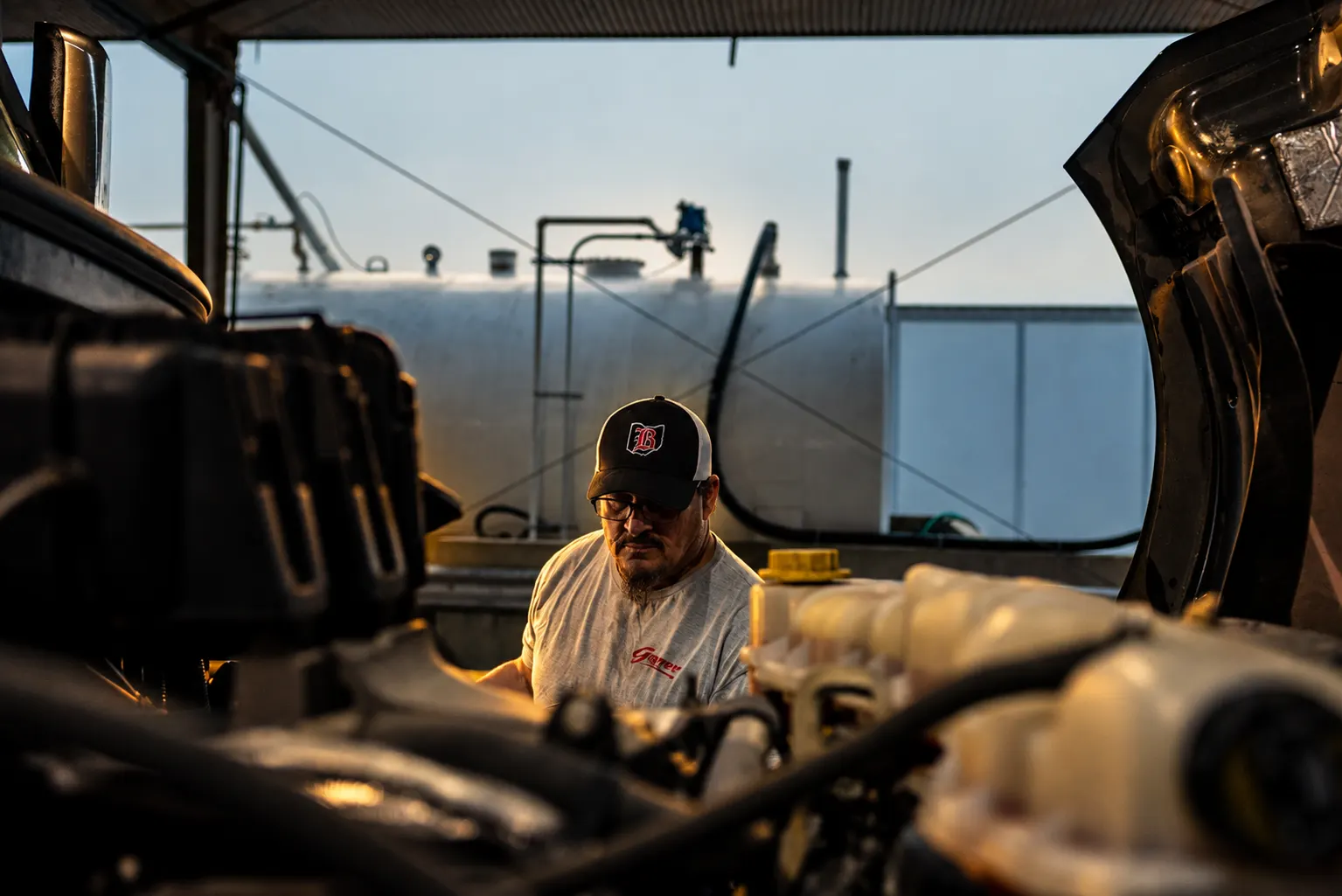 Ohio worker in a cap servicing equipment in a workshop